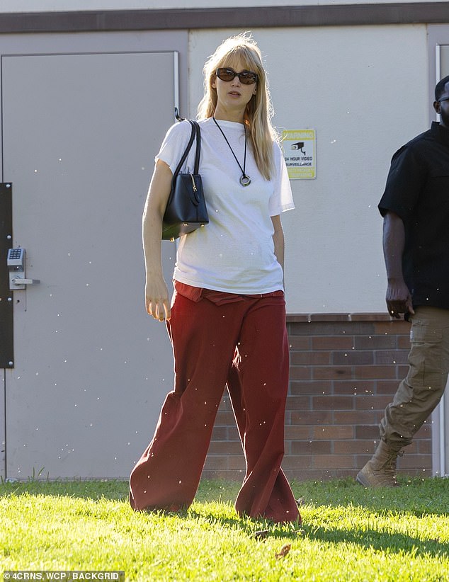 Jennifer Lawrence shows off her baby bump in a white shirt as she takes son Cy, two, to a Los Angeles park