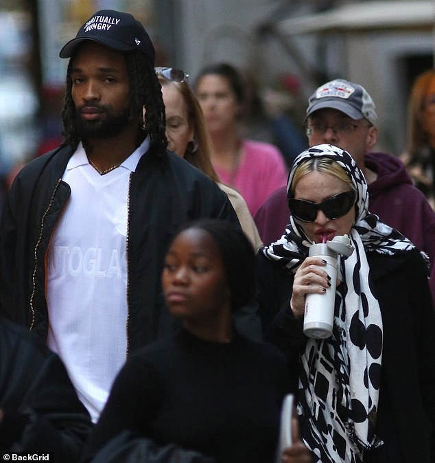Madonna, 66, looks unrecognizable in a head scarf and coat while out with boyfriend Akeem Morris, 28, in NYC