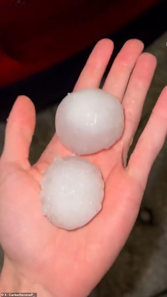 Cars are smashed by giant golf-ball-sized hailstones as violent storm hits Spain
