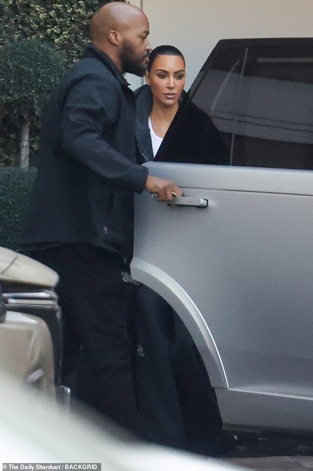 Kim Kardashian sports edgy black trench coat as she visits skin care clinic in Beverly Hills