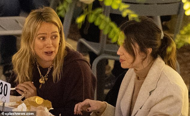 Hilary Duff is in great spirits as she joins her close friend Mandy Moore for a casual outdoor dinner in Los Angeles… after revealing fitness hack