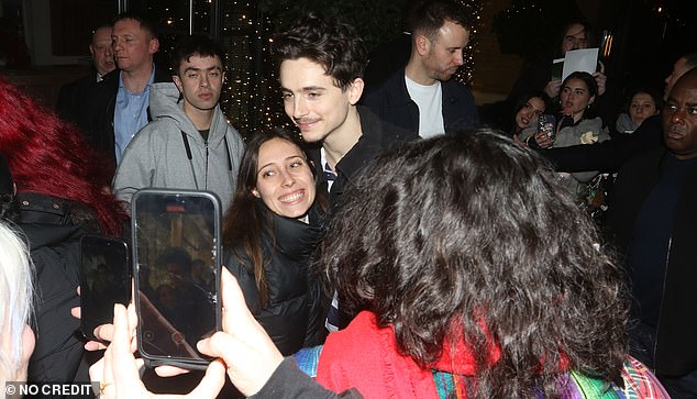 Timothée Chalamet is mobbed by a sea of adoring fans as he leaves a screening of his film A Complete Unknown
