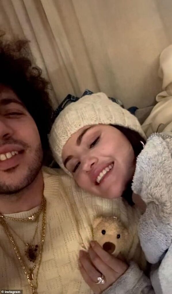 Selena Gomez flashes engagement ring as she and fiance Benny Blanco cuddle up to sing Christmas carols