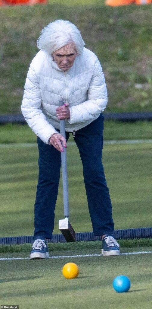 Dame Mary Berry is a picture of concentration as she takes a swing at croquet just four years after former Bake Off star broke her hip