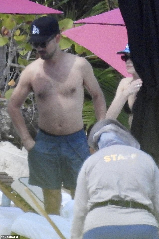 Twilight star looks unrecognizable from his pin up days while on the beach… can you guess who?
