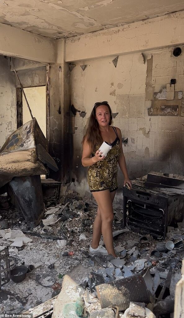 British mother breaks down in tears as she surveys the smouldering remains of her Cyprus villa after family was forced to flee deadly wildfires with seconds to spare