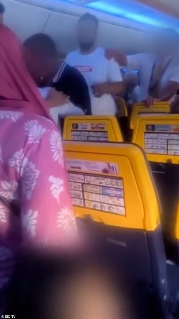 Footage shows chaos on board UK Ryanair flight as ‘brawl sparked by crying baby sees police called and passengers held on the plane for an hour after landing’