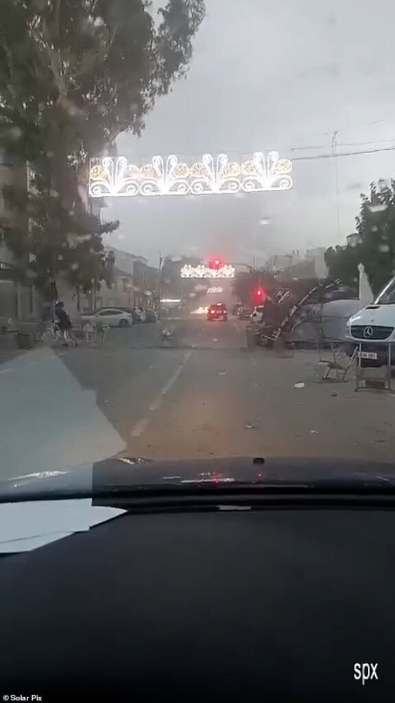 Terrifying moment tornado sweeps through Spanish town sending tables and chairs flying as country continues to battle wildfires amid freak heatwave weather