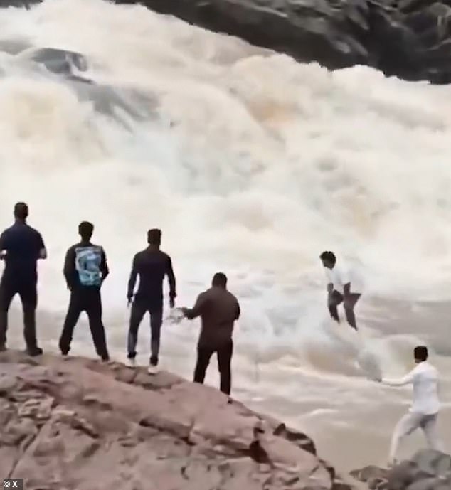 Horrifying moment YouTuber, 22, is swept away in waterfall after wading into a raging river to pose for a drone video