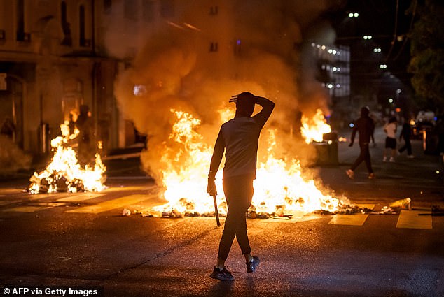 Switzerland at boiling point: Fears stable country could face more riots as anger spills onto streets after spate of police-related deaths including migrant teen killed fleeing officers