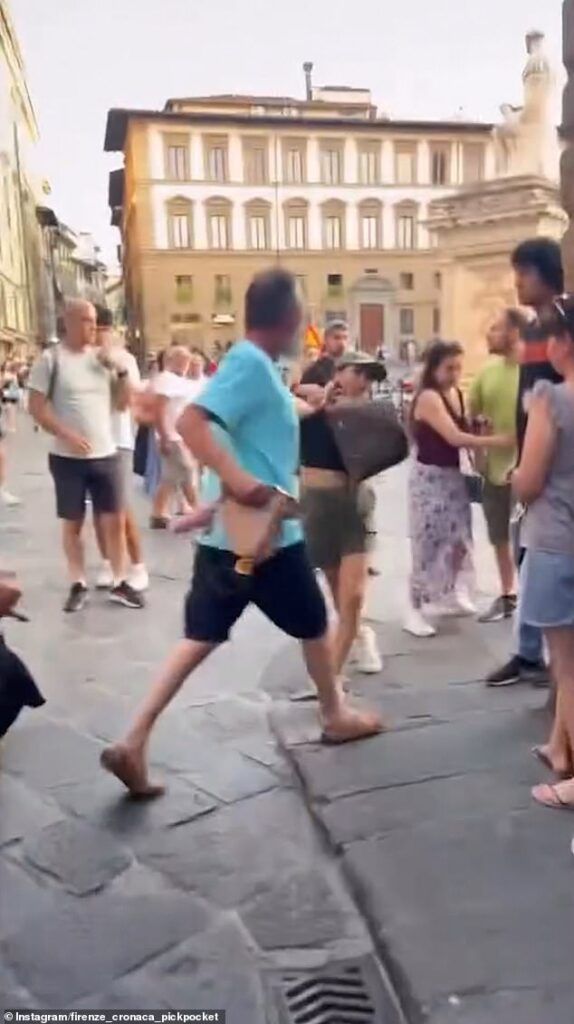 Moment ‘pickpocket’ is grabbed by the hair by irate husband who ‘spotted her stealing from his wife’… before ‘thief’ demands they free her because she’s pregnant