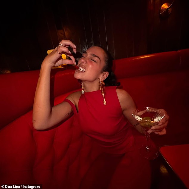 Dua Lipa looks glamorous in a stylish red co-ord as she playfully poses for fun snaps after showcasing her impressive yoga moves