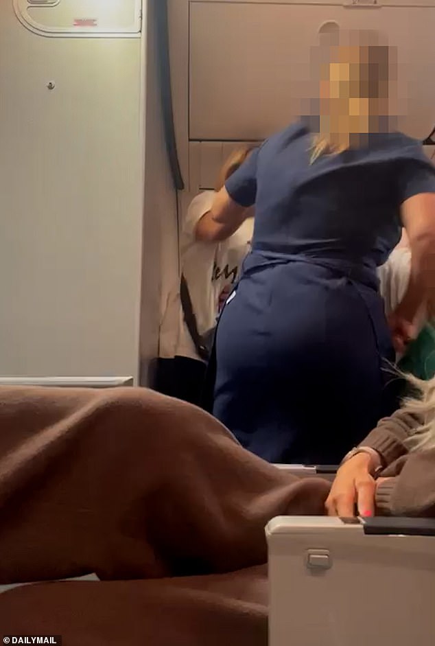 Shocking moment British woman forces plane to divert to Crete after shoving stewardess and screaming at passengers after row sparked by someone kicking the back of her seat